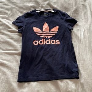 Kids size medium adidas shirt, logo is coral pink while rest of shirt is navy